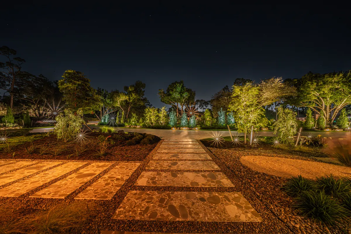 Paver walkway at night with lighting integrated cleanly into the hardscape