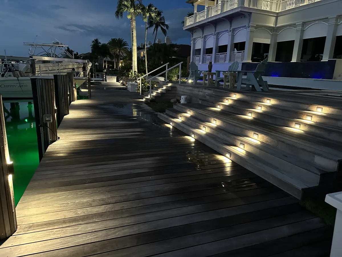 Waterfront dock at night with step lighting and water reflections