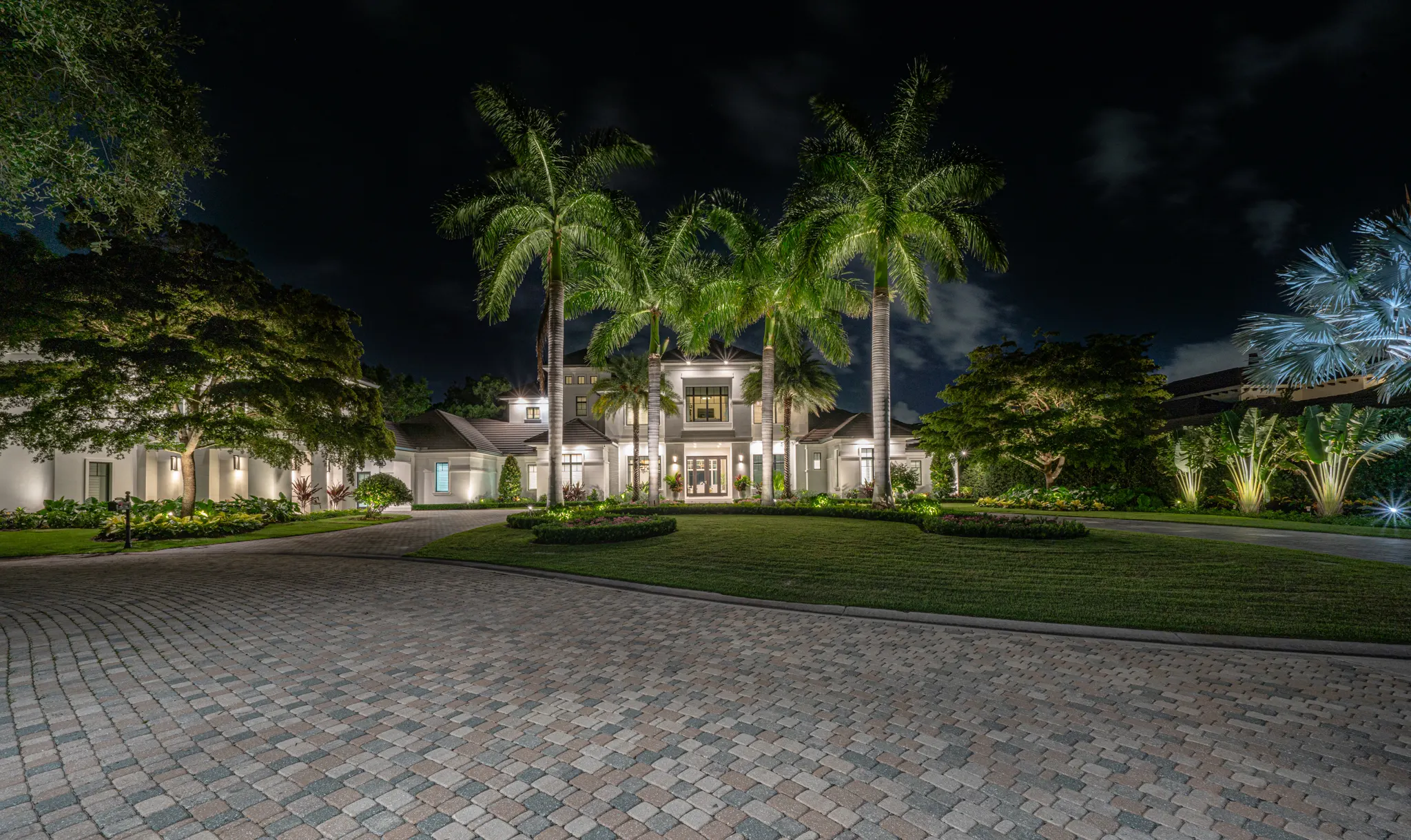 Naples estate revealed by light — landscape lighting by Spectrum Nightscapes