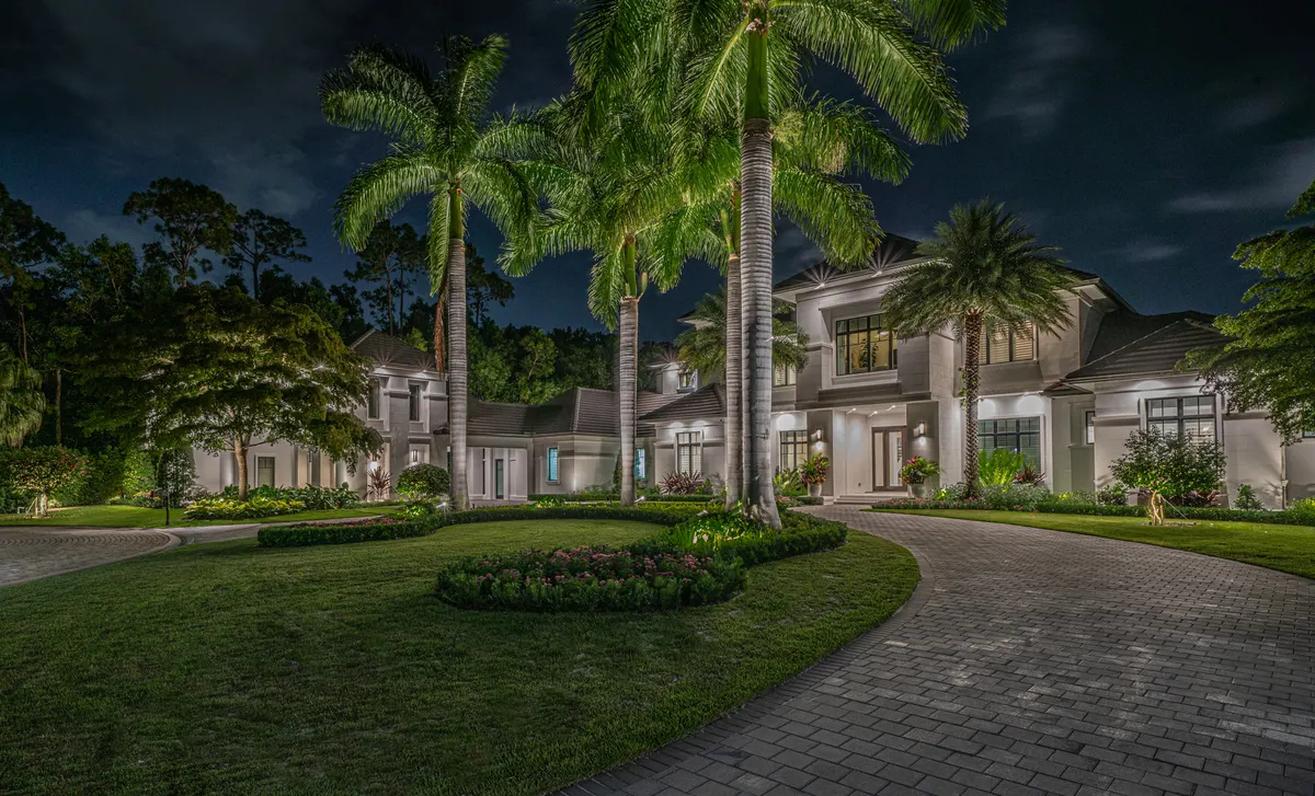 Layered landscape lighting design on a Naples estate: canopy, architectural, and pathway lighting