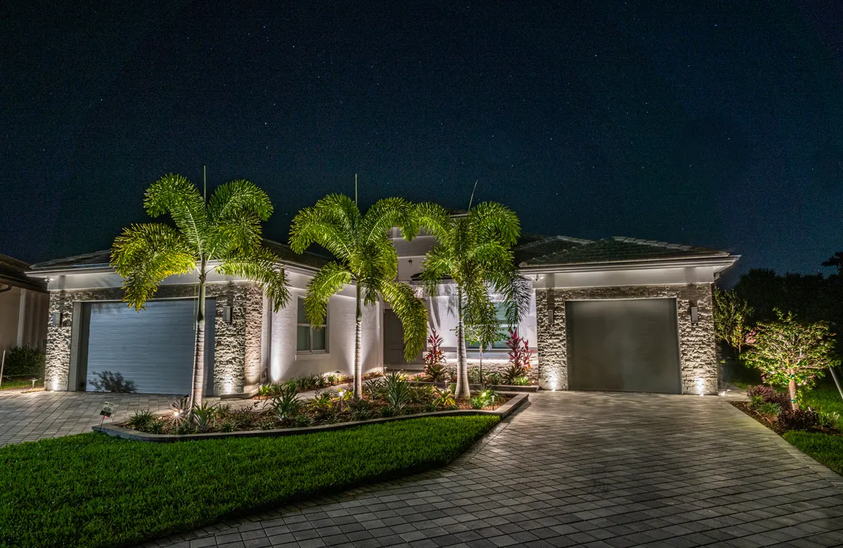 Southwest Florida home with warm pool and lanai lighting at night